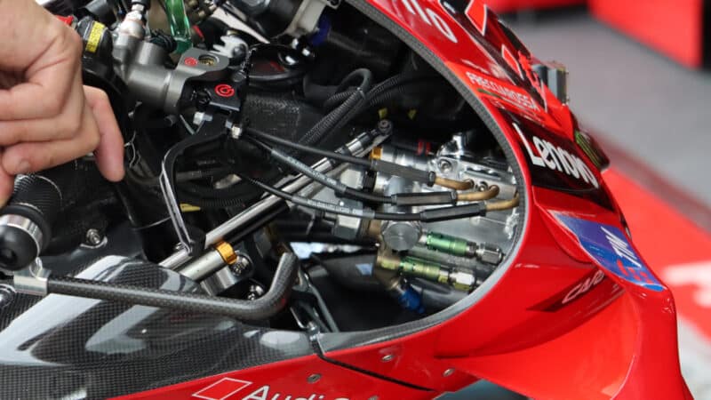 Ride-height adjuster plumbing in the fairing nose of a 2025 Ducati. All such devices will be banned from 2027